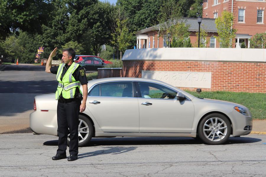 A public safety officer directs traffic.